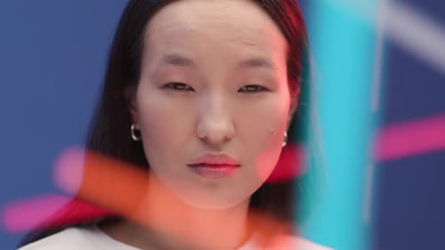 Young asian woman smiles in neon light for technology advertising