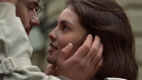 Affectionate couple enjoying tender moments and smiling on a romantic date in the city