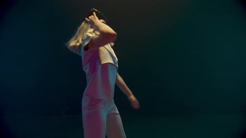 Cyber Girl Dancing Virtual Reality Glasses in Neon Lights. Happy Player Enjoying