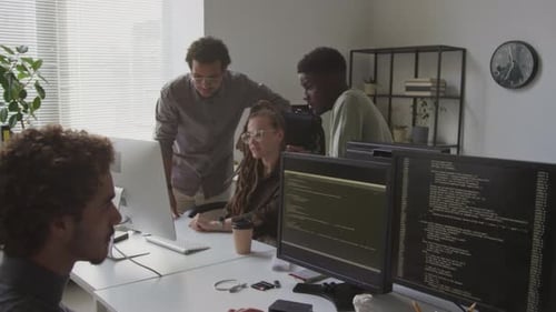 Software Engineers Discussing Computer Program at Workplace
