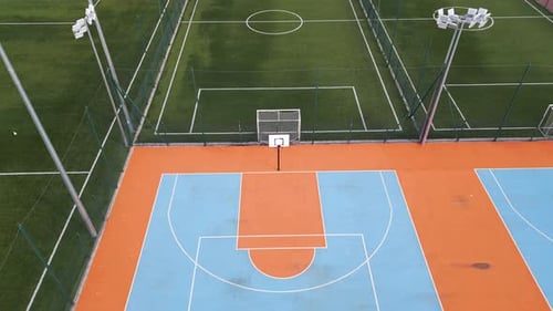 Aerial View of Outdoor Basketball and Soccer Courts with Vibrant Blue Orange and Green Colors The