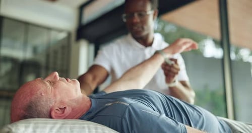 Senior man, stretching and physical therapy in clinic, physiotherapist and arm exercise