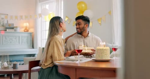 Couple, kiss and gift for birthday celebration, love and happy relationship together at home