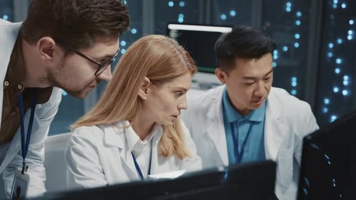 Scientists Working Together in Futuristic Tech Workspace