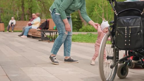 Adult Female Helping Adorable Infant Learning to Walk