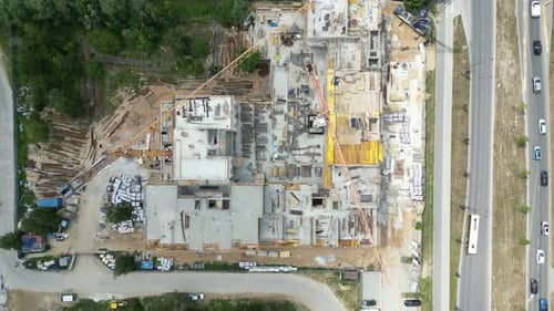 Aerial view of construction site with crane and building. Top view of big development construction a