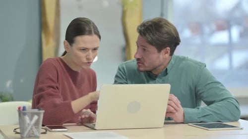 Woman and Man Collaborating in an Office