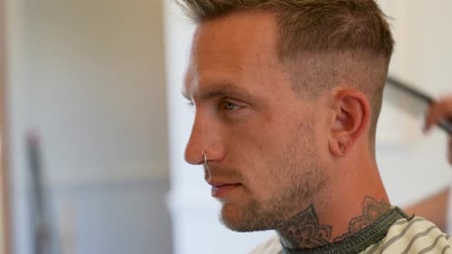 Man Getting Haircut at Modern Barbershop