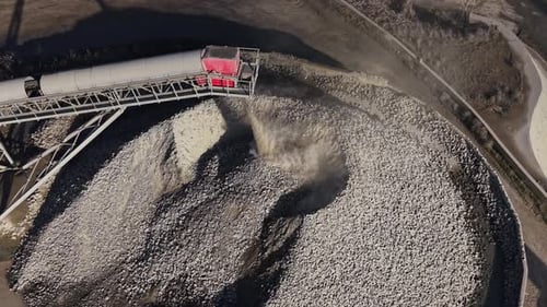 Quarry operation showing stone processing and transport through machinery