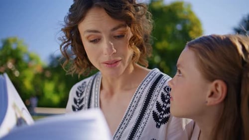 Mom Child Holding Book Gathering in Cozy Garden Closeup Lady and Kid Talking