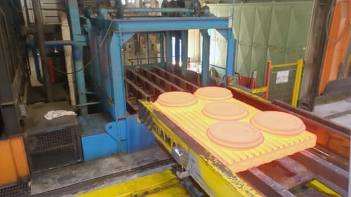 Metal parts inside an industrial furnace during forging process. Manufacturing of jet turbine parts