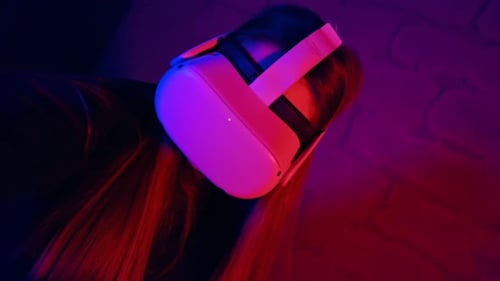 Woman Wearing VR Headset with Blue and Red Lighting