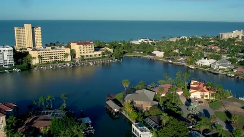 Luxury homes and condos line a beautiful tropical beach in naples Florida