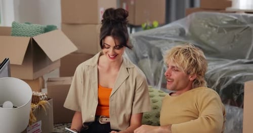 Couple planning their move in a new home