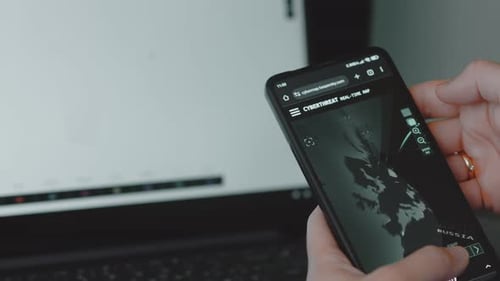 Smartphone Displaying Cyber Threat Real-Time Map