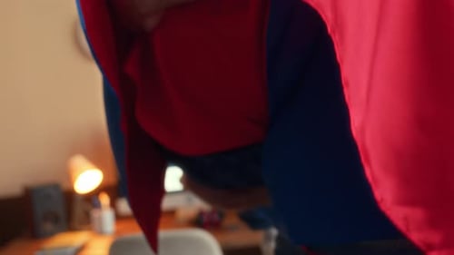 Father and Son Play Superheroes at Home