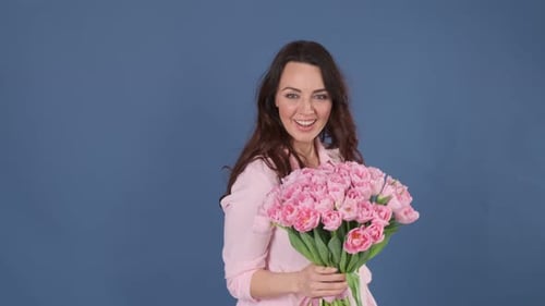 Smiling Brunette Woman Holding Pink Tulip Bouquet