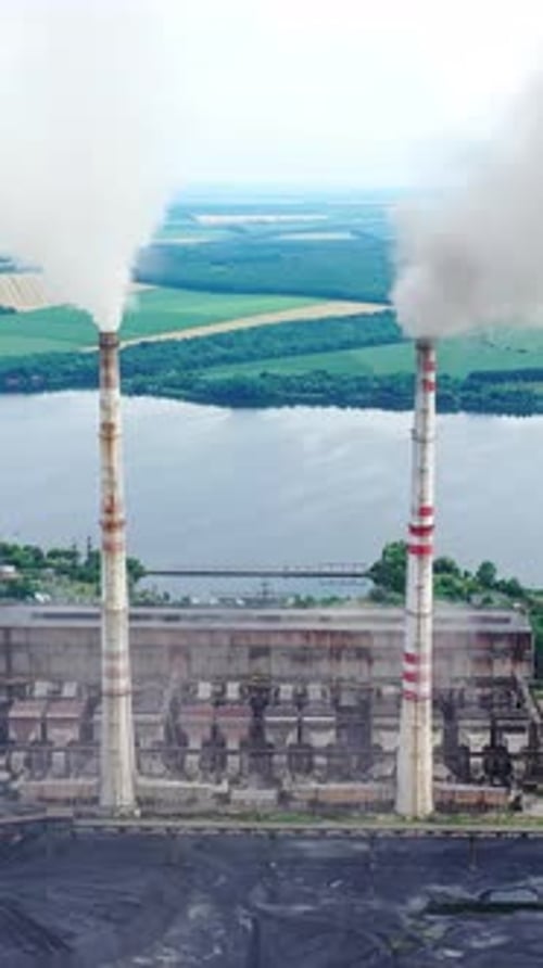 Factory with smokestacks near the river.