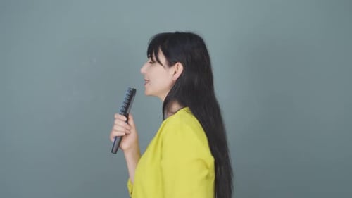 The woman is singing.