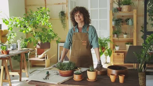 Woman Smiles in Indoor Garden Setting