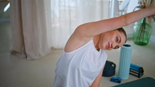 Woman Stretching Arm Muscles Before Workout at Home