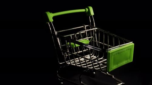 Illuminated Miniature Shopping Cart on Black Background