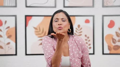 Smiling Woman Blowing a Kiss to Camera