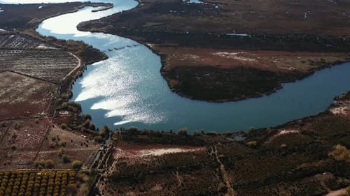 Drone shot, 4K Ariel view of blue lake with stones and brown land. Aerial view of Dalyan river and t