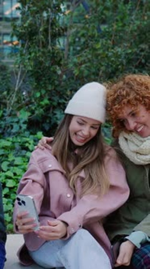 Two Smiling Young Women Taking a Selfie
