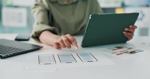 Person, hands and app designer with wireframes on tablet for UI design, UX or development in office