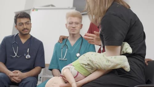 First aid. Baby held by doctor in medical clinic
