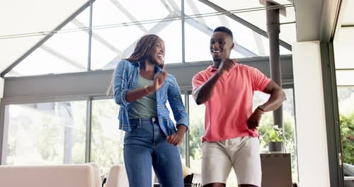 Cheerful Couple Dancing Together in Modern Home