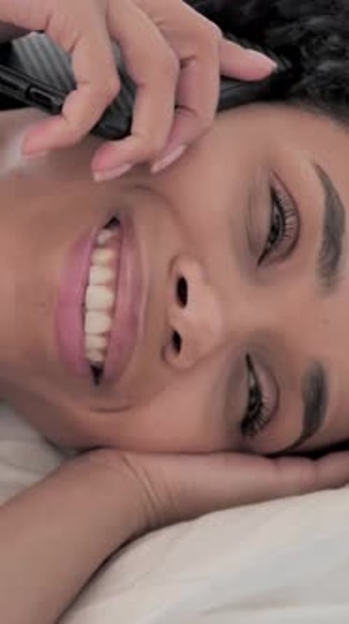 Woman Talking on Phone While Lying in Bed