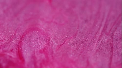 Flowing Pink Liquid with Glittering Particles Macro Shot