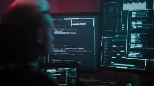 Woman Hacker Carefully Scans Monitors in Search of Virus