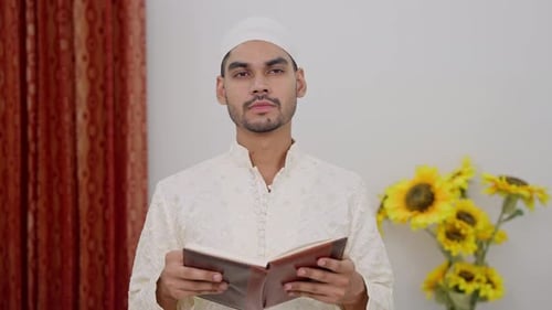 Young Adult Reading Religious Book Indoors