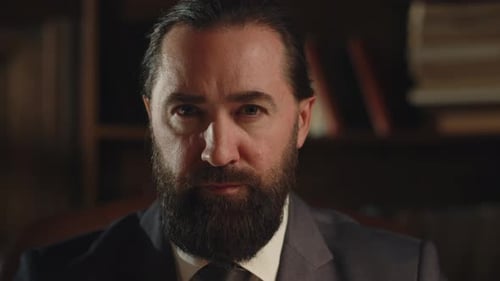 A Bearded Man Businessman Sits in His Office and Thinks About Something A Man in a Business Suit