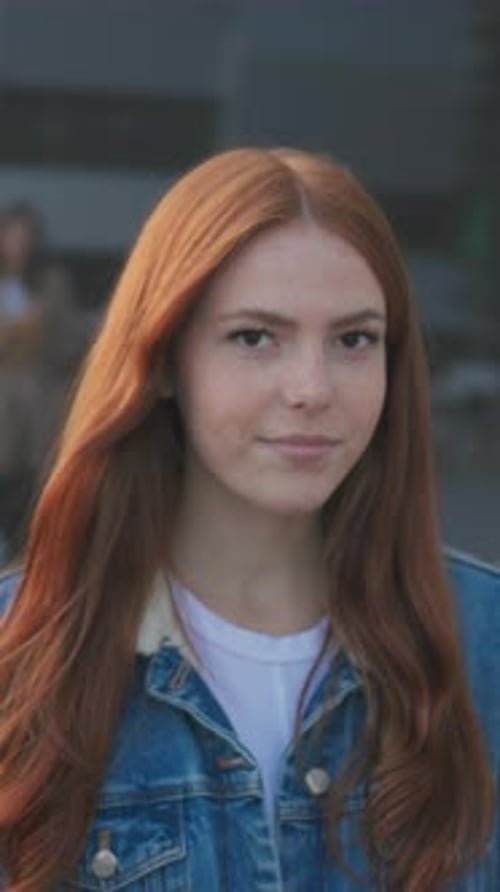 Casual Female Outdoors Smiling Urban Evening Scene Featuring Thoughtful Young Woman with Freckles