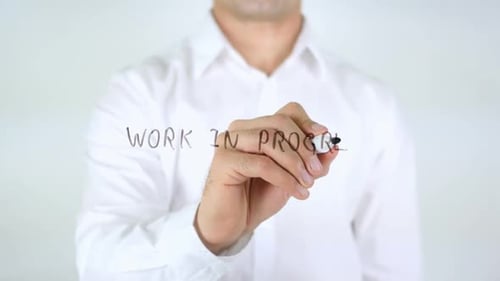 Man Writes 'Work In Progress' on Glass