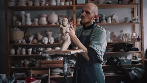Young Skillful Craftsman Sculpting a Clay Statue of a Woman in Garage Potting Workshop