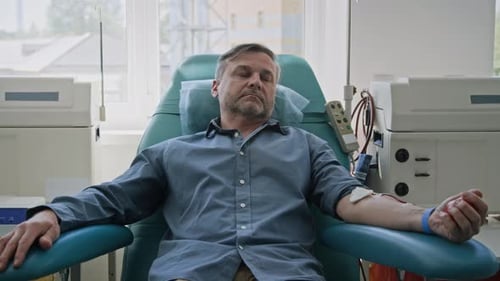 Middle-Aged Man Donating Blood in clinic