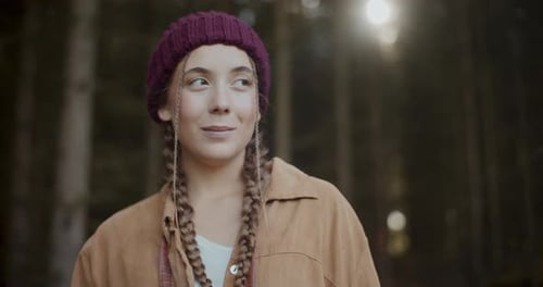 Young Woman with Binoculars Explores Forest
