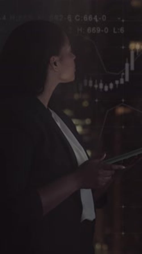 Business Woman using Digital Tablet in Office, Looking at Stock Market Data