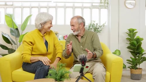 Senior Couple Video Chatting on Smartphone at Home