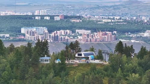 A Majestic Bus Parked on a Serene and Vibrant Green Hilltop Overlooking Nature's Splendor