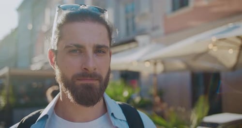 Sunlight Close Up Portrait of Attractive Man Standing Outdoors Colorful Urban Street Concept of