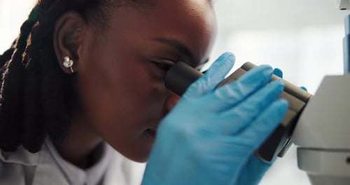 Close Up of Woman Using a Microscope