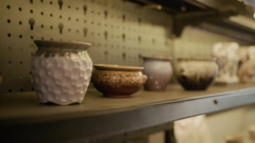 Shelf with Glazed Clay Pots in Workshop