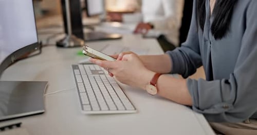 Closeup of Female Hands Networking on Social Media with Phone in Office