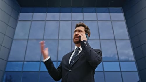 Angry Executive Arguing Mobile Phone Gesturing Expressively Near Office Closeup